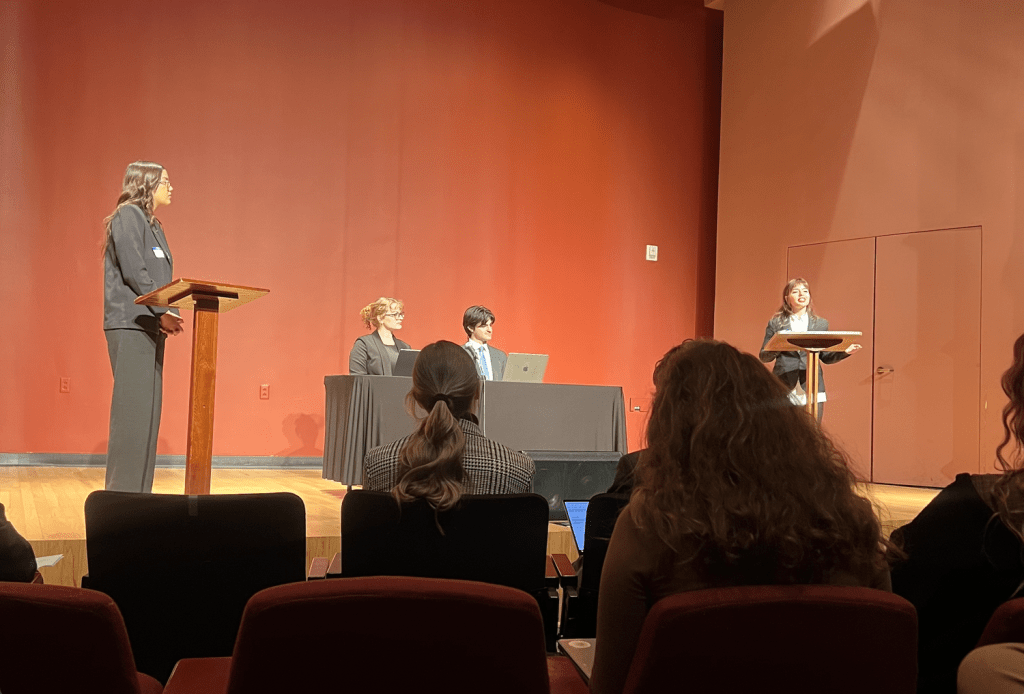 Sophomore class presidential candidates Sophia Espinosa (left) and Adelle Tupsehva (right) discuss policy and their individual campaign goals. Debaters Ashleigh Weinstock (left center) and Chris Hamden (right center) moderated the event.